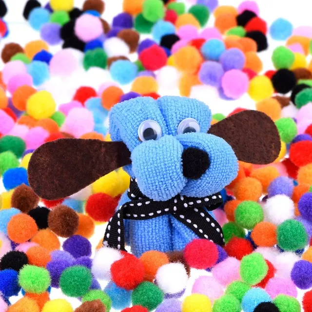 Coloured pom-poms spread around a knitted toy dog